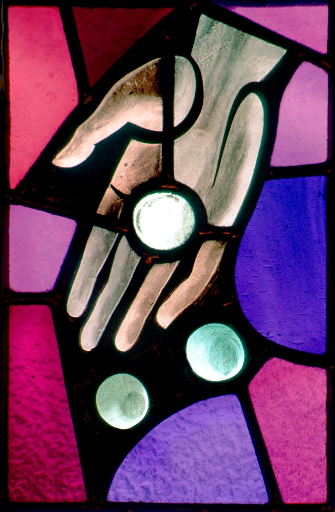 WINDOW ILLUSTRATES PRACTICE OF ALMSGIVING